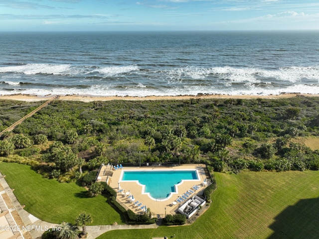 bird's eye view with a water view and a beach view