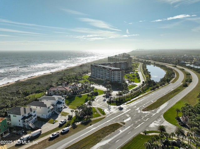 birds eye view of property with a water view and a view of the beach