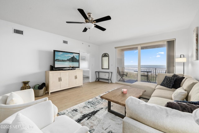 living room featuring light wood-type flooring and ceiling fan