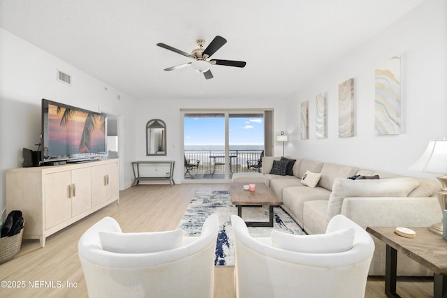 living room with light hardwood / wood-style floors and ceiling fan