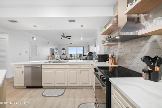 kitchen featuring tasteful backsplash, pendant lighting, stainless steel appliances, and sink