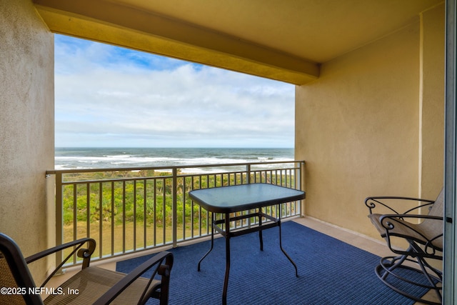 balcony with a view of the beach and a water view