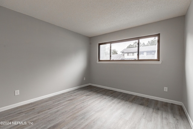 9360 Craven Rd Unit 504, Jacksonville, FL 32257 - spare room with a textured ceiling, baseboards, and wood finished floors