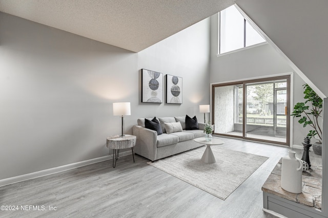 9360 Craven Rd Unit 504, Jacksonville, FL 32257 - living area featuring baseboards, wood finished floors, a towering ceiling, and a textured ceiling