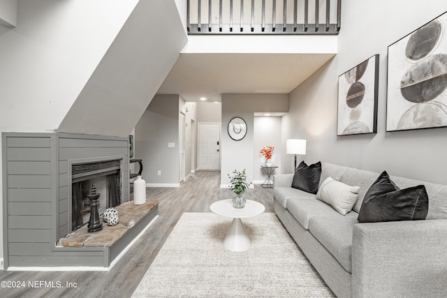 9360 Craven Rd Unit 504, Jacksonville, FL 32257 - living area with a towering ceiling, baseboards, wood finished floors, and a fireplace with raised hearth
