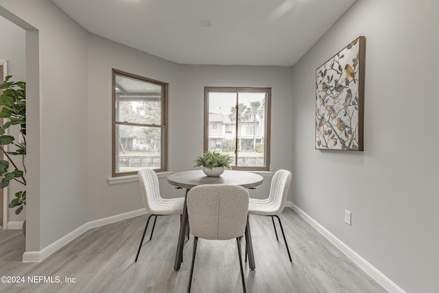 9360 Craven Rd Unit 504, Jacksonville, FL 32257 - dining area with baseboards, light wood-style floors, and a healthy amount of sunlight