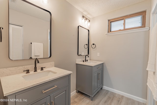 9360 Craven Rd Unit 504, Jacksonville, FL 32257 - full bathroom with a textured ceiling, a sink, two vanities, and wood finished floors