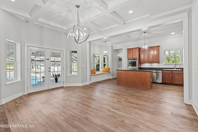 kitchen with french doors, hanging light fixtures, stainless steel appliances, sink, and hardwood / wood-style floors