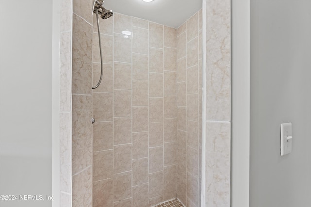 bathroom with tiled shower