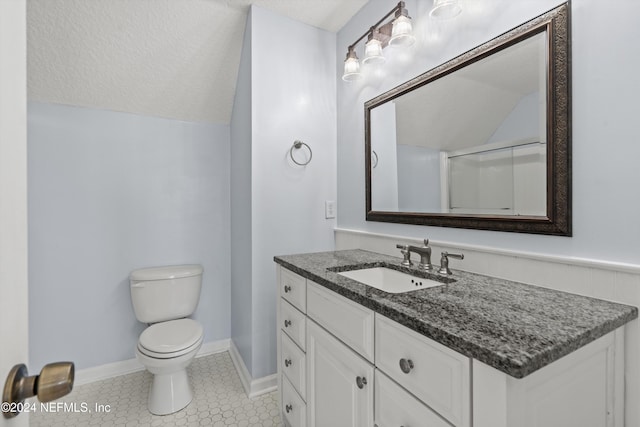 bathroom featuring a shower with door, toilet, vaulted ceiling, vanity, and a textured ceiling