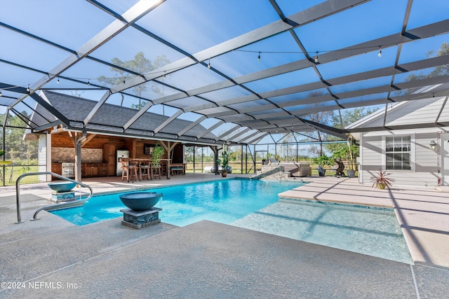 view of swimming pool featuring a patio, a hot tub, and a lanai