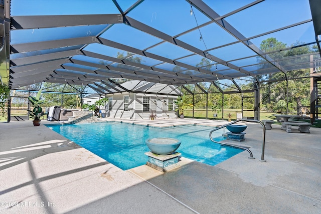 view of swimming pool with a patio, pool water feature, and glass enclosure