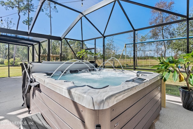 view of patio with a hot tub and glass enclosure