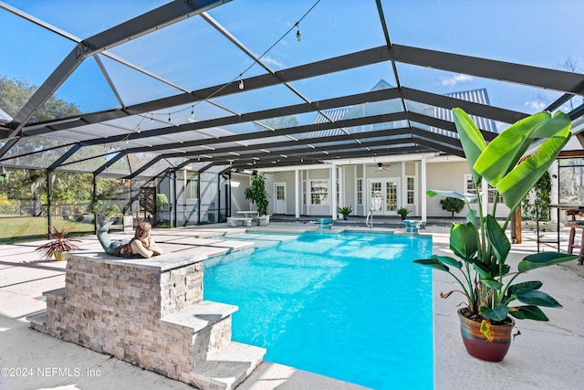 view of pool featuring a patio, french doors, a lanai, and ceiling fan