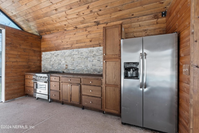 kitchen featuring lofted ceiling, appliances with stainless steel finishes, wood ceiling, and wood walls