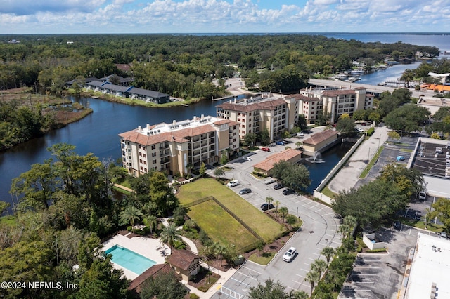 bird's eye view with a forest view and a water view