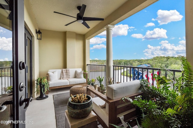 balcony with an outdoor living space and ceiling fan