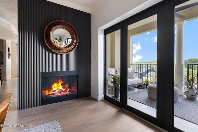 entryway with ornamental molding and hardwood / wood-style flooring