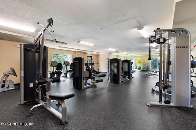 workout area featuring a textured ceiling