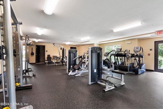 exercise room with a textured ceiling