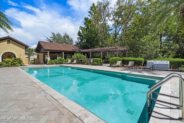 view of pool with a pergola and a patio