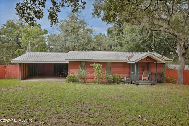 view of front of property with central AC and a front yard