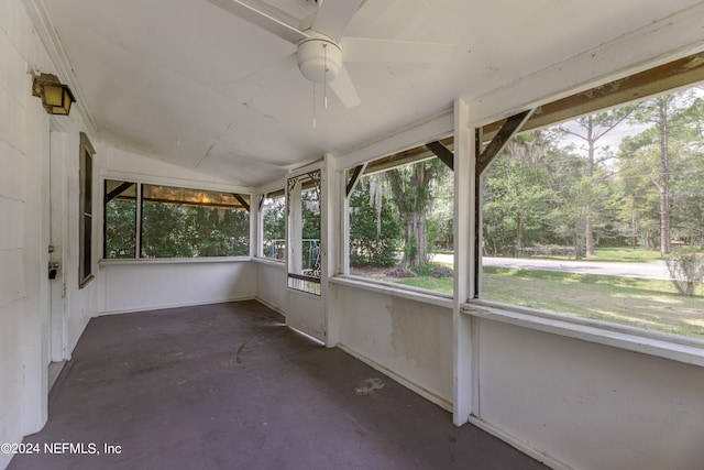 unfurnished sunroom featuring ceiling fan and vaulted ceiling