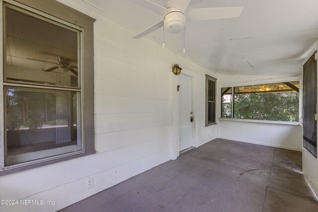 unfurnished sunroom featuring ceiling fan