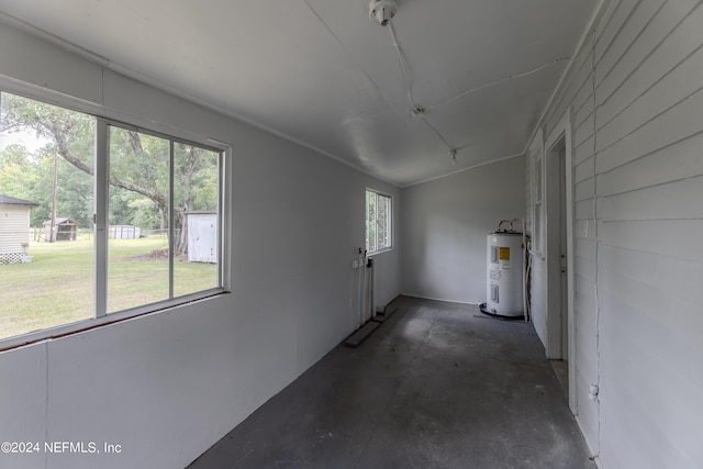 unfurnished sunroom with lofted ceiling and electric water heater