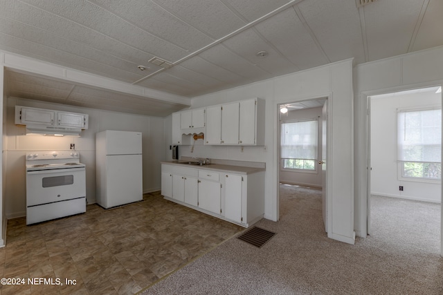 kitchen with white cabinets, white appliances, carpet floors, and sink