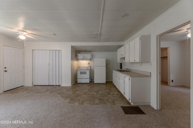 kitchen featuring white appliances, sink, white cabinetry, light colored carpet, and ceiling fan