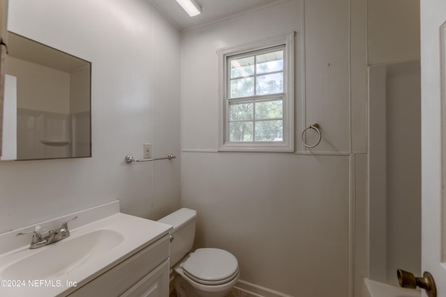 bathroom with walk in shower, toilet, and vanity