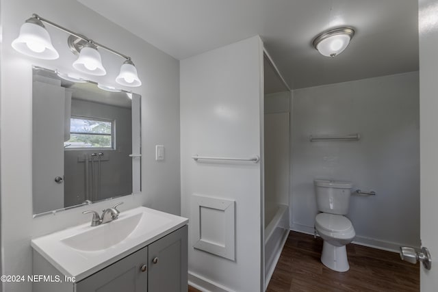 full bathroom featuring vanity, toilet, shower / washtub combination, and hardwood / wood-style flooring