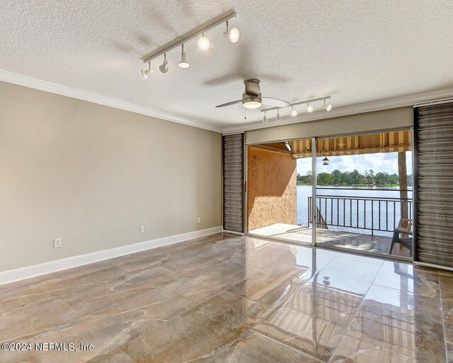 unfurnished room featuring track lighting, ceiling fan, crown molding, and a textured ceiling