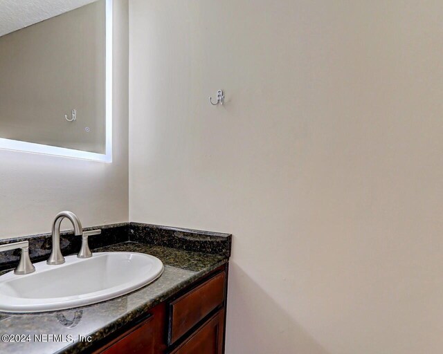 bathroom with vanity and a textured ceiling