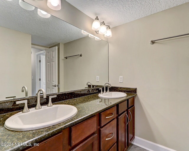 bathroom featuring vanity and a textured ceiling