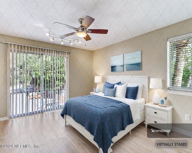 bedroom with access to exterior and ceiling fan