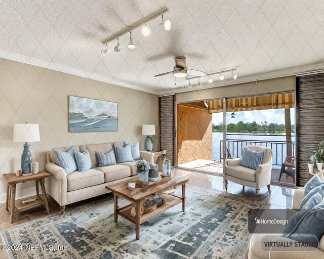 living room with crown molding, rail lighting, and ceiling fan