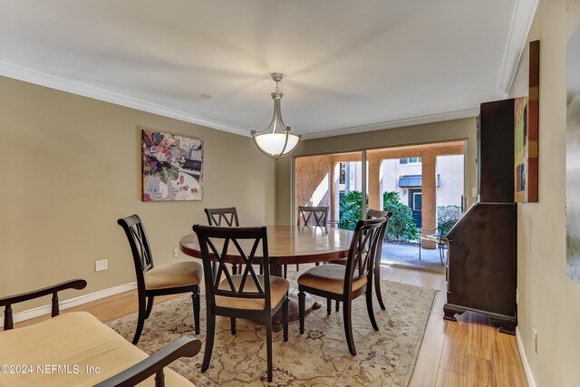 dining room featuring ornamental molding and light hardwood / wood-style floors