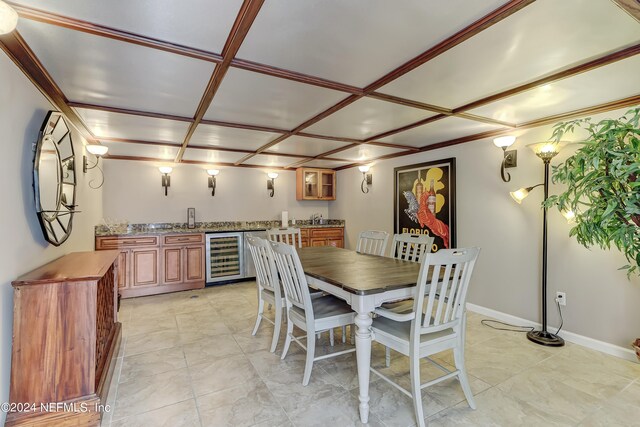 dining room with indoor wet bar, coffered ceiling, and wine cooler