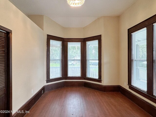 unfurnished room with hardwood / wood-style flooring