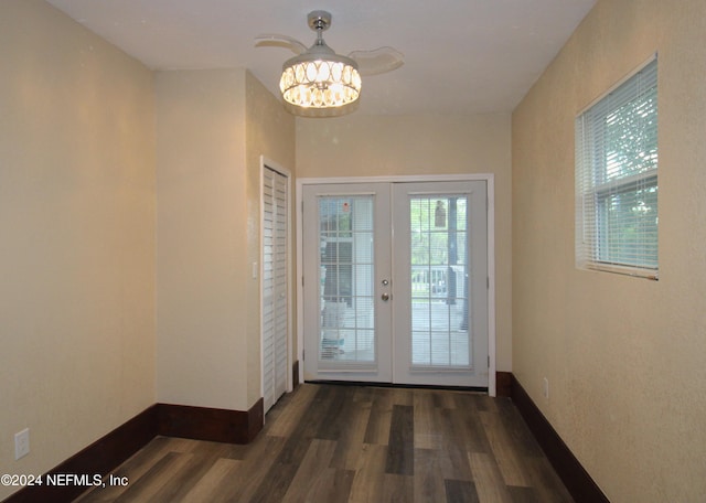 entryway featuring french doors, a notable chandelier, and dark hardwood / wood-style floors