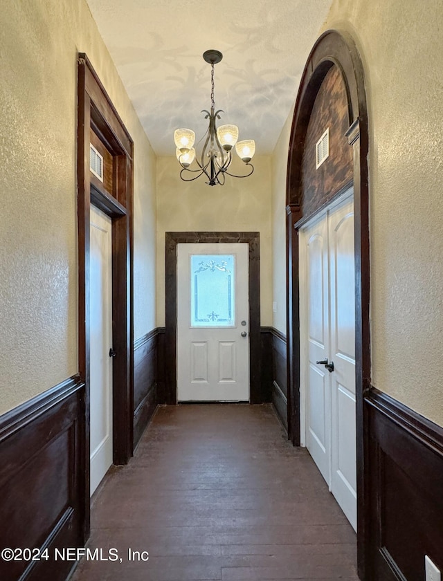 interior space with a notable chandelier and hardwood / wood-style flooring