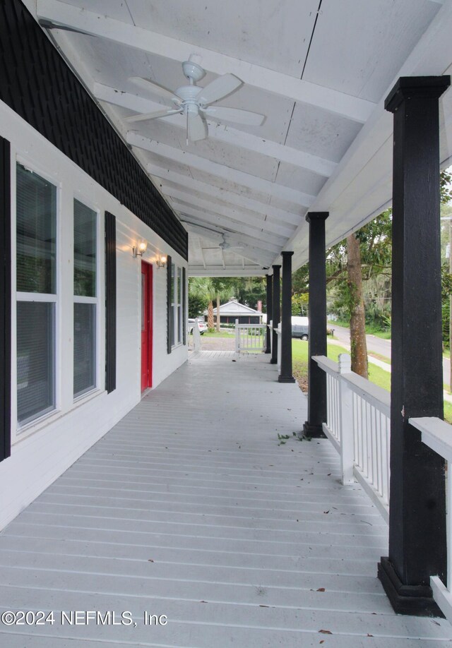 wooden deck featuring covered porch and ceiling fan