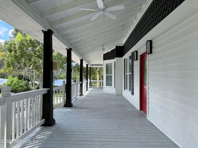 wooden terrace featuring a porch and ceiling fan