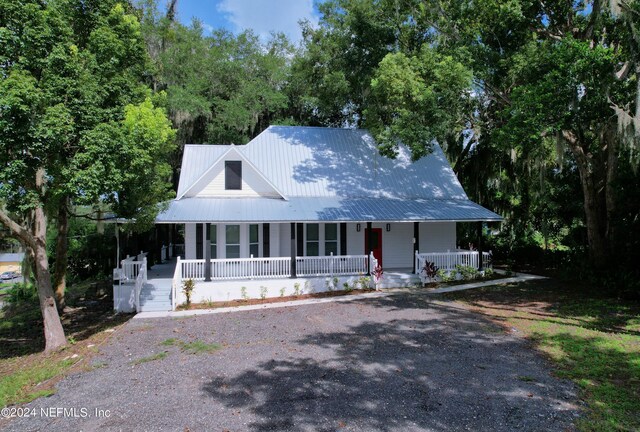 country-style home featuring covered porch