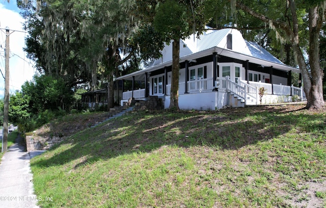 view of front of home with a front yard and a porch