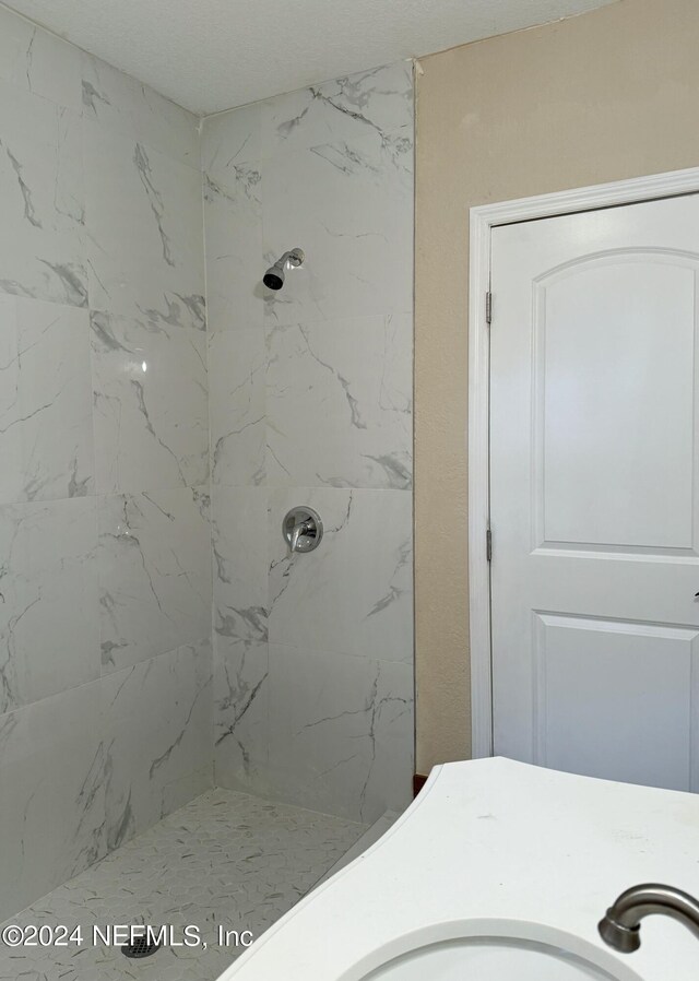 bathroom with tiled shower