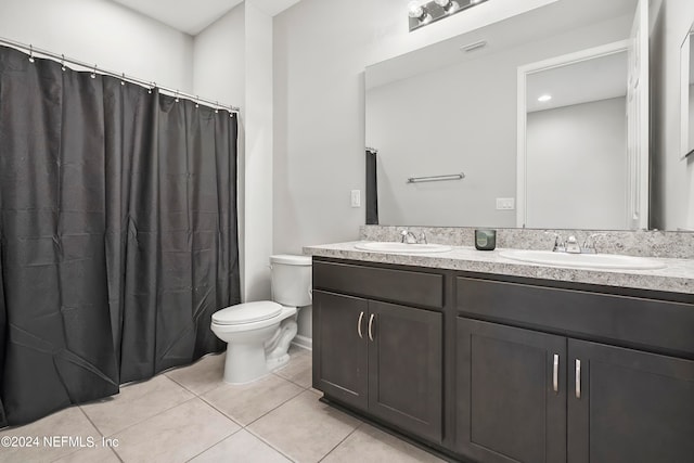 bathroom with toilet, walk in shower, vanity, and tile patterned flooring