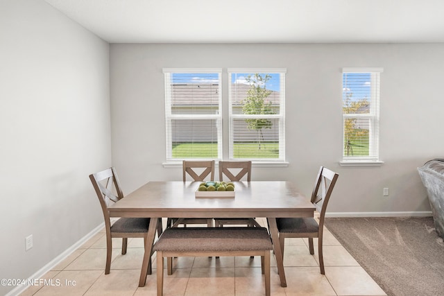 dining space featuring light tile patterned floors